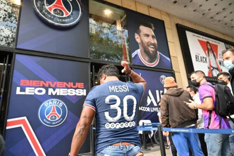 A supporter wears a jersey bearing Lionel Messi's PSG shirt and number.