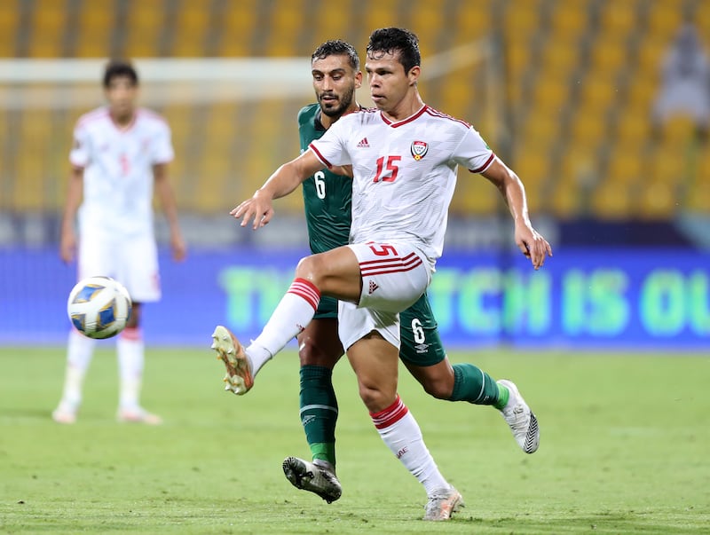 Fabio De Lima of the UAE vies for the ball with Ali Adnan of Iraq. Chris Whiteoak / The National