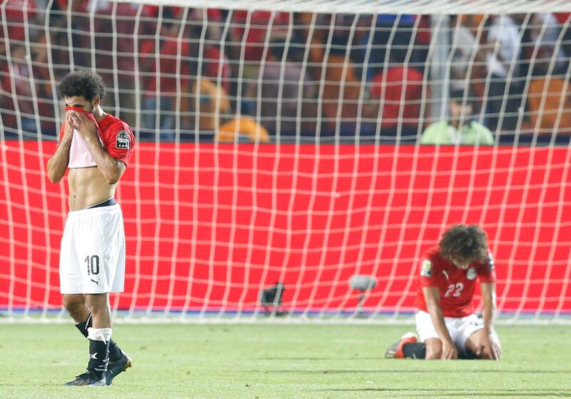 Egypt's Mohamed Salah, left, and Amp Warda react after the African Cup of Nations round of 16 soccer match between Egypt and South Africa in Cairo International stadium in Cairo, Egypt, Saturday, July 6, 2019. (AP Photo/Ariel Schalit)