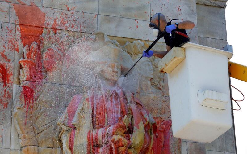 A member of the New York City Monuments and Conservation department power washes the statue of former US President George Washington after the statue got covered in red paint after being vandalised in Washington Square Park in New York.  EPA