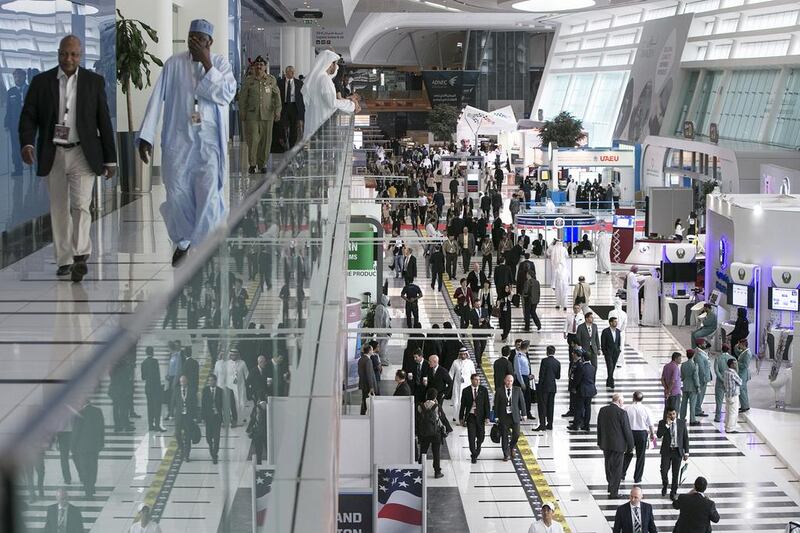 Visitors peruse the exhibition at the Abu Dhabi National Exhibition Center. Silvia Razgova / The National