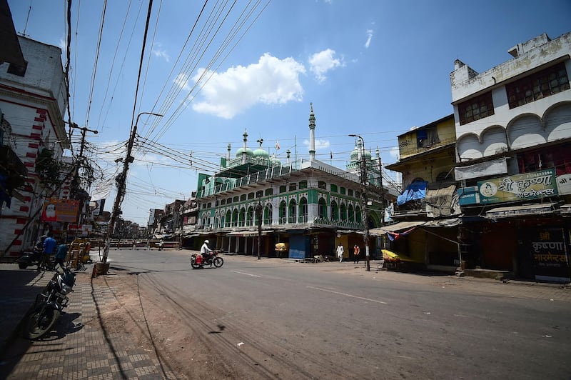 A man crosses an empty road during a weekend lockdown imposed by the government as a preventive measure against the Covid-19 coronavirus, in Allahabad. AFP