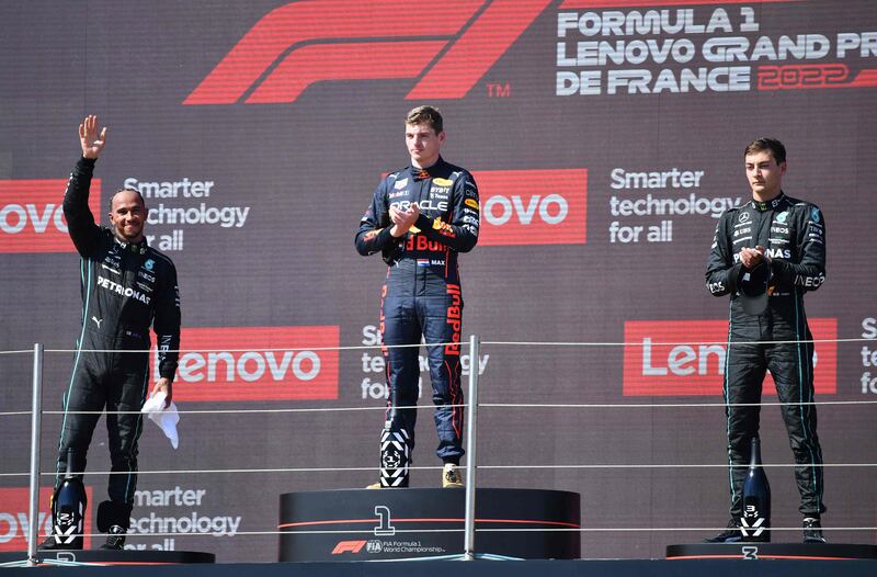 Lewis Hamilton, Max Verstappen and third placed  George Russell on the podium. AFP