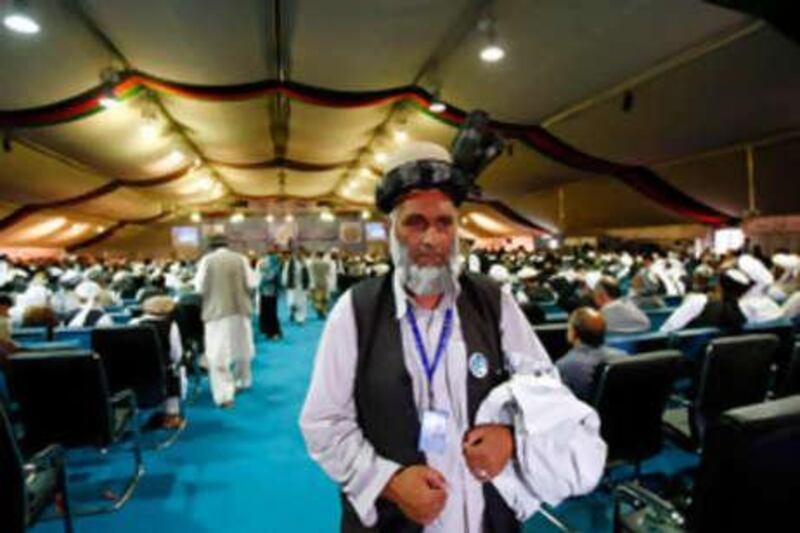 A delegate leaves the peace jirga tent after hearing blasts from a rocket attack in Kabul.