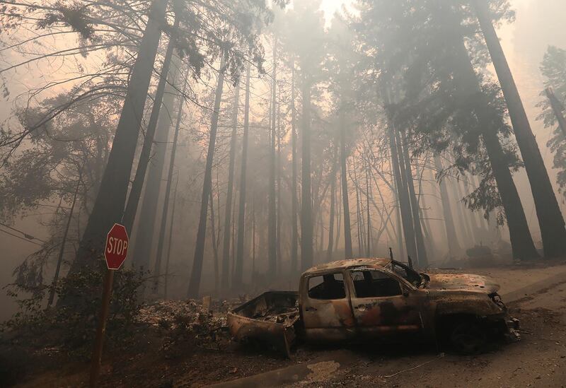 A burned-out vehicle is seen along Highway 236 in Boulder Creek, California. AP