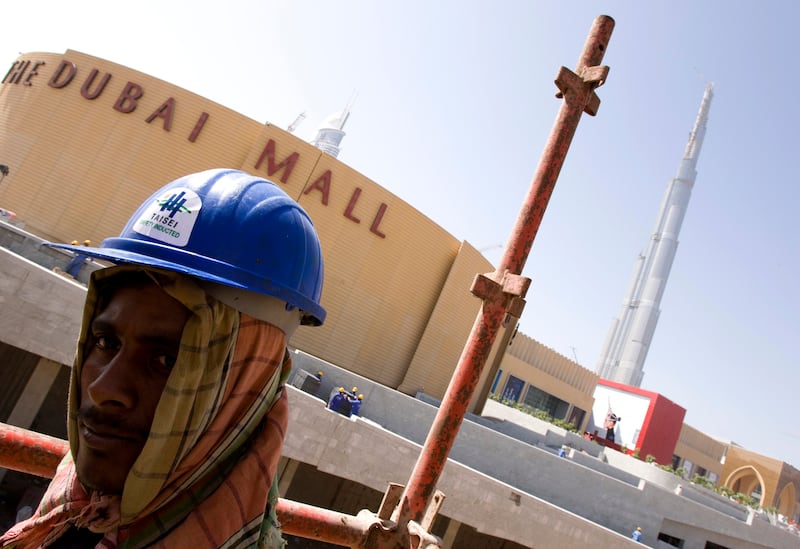 A worker at a construction site near Dubai Mall in October 2008, days before the shopping centre's official opening. Reuters 