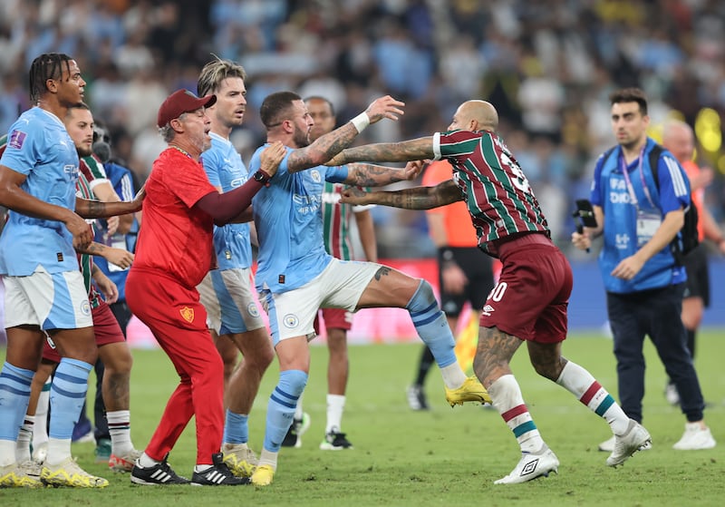 Manchester City's Kyle Walker scuffles with Fluminense's Felipe Melo. EPA