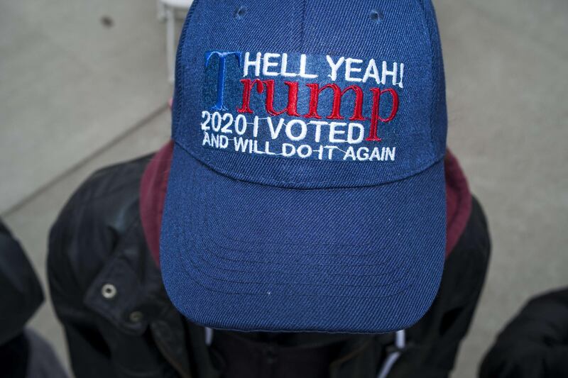 An unidentified rally attendant wears a hat in support of President Donald Trump during a rally with Vice President Mike Pence at the Range Regional Airport in Hibbing, Minnesota. Pence will continue to campaign despite five members of his staff testing positive for coronavirus (COVID-19).  Getty Images