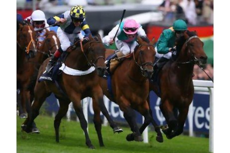Mac Love, left with jockey in blue and yellow, winning at England's Epsom course. Jamie McDonald / Getty Images
