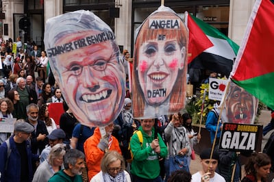 Demonstrators hold images of the Labour leader Keir Starmer and deputy leader Angela Rayner. Photo: Getty Images
