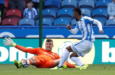 Soccer Football - Premier League - Huddersfield Town vs Southampton - Huddersfield, Britain - August 26, 2017   Southampton's Fraser Forster saves from Huddersfield Town’s Elias Kachunga   REUTERS/Phil Noble    EDITORIAL USE ONLY. No use with unauthorized audio, video, data, fixture lists, club/league logos or "live" services. Online in-match use limited to 45 images, no video emulation. No use in betting, games or single club/league/player publications. Please contact your account representative for further details.