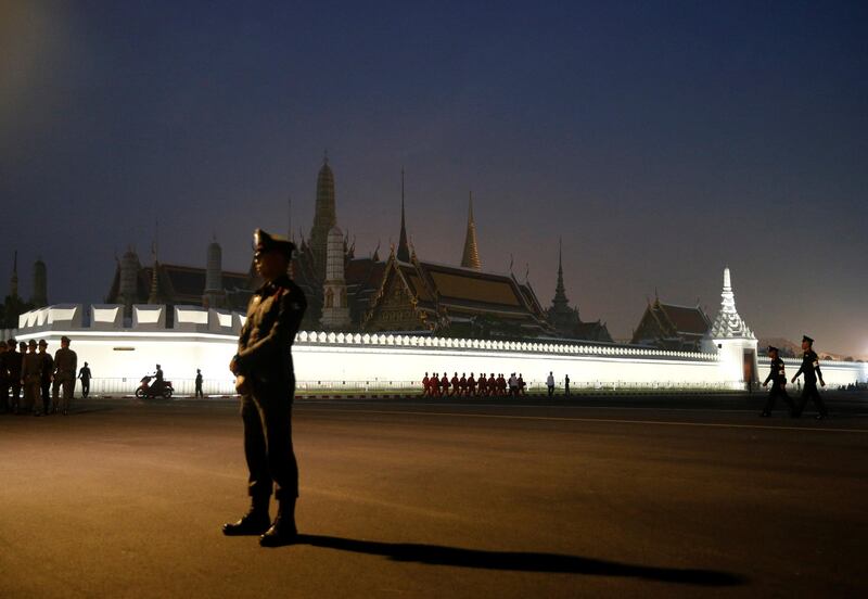 A police officer stands guard before the Royal Cremation ceremony. Soe Zeya Tun / Reuters.