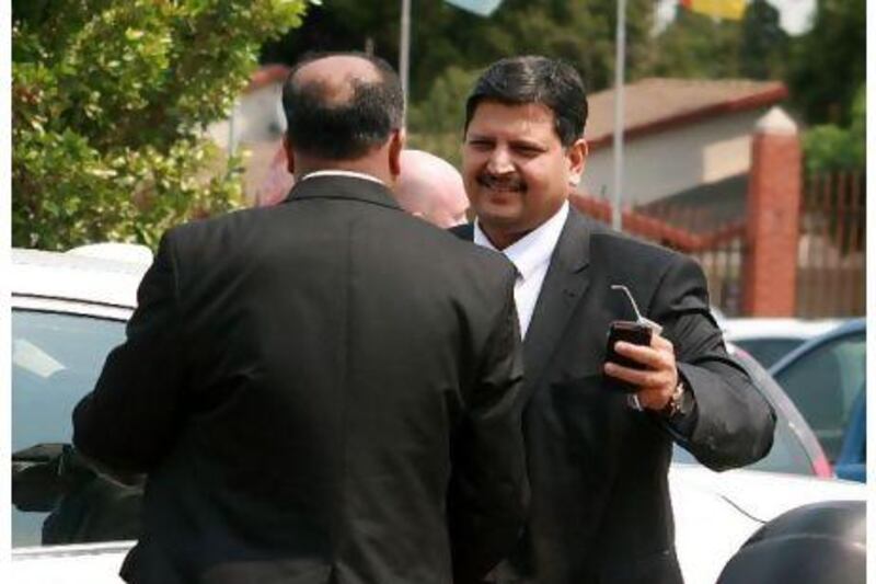 JOHANNESBURG, SOUTH AFRICA - SEPTEMBER 27: (SOUTH AFRICA, UAE, BRAZIL, TURKEY OUT) South African billionaire publisher Atul Gupta (R) attends Randburg Magistrate's court on September 27, 2010 in Johannesburg, South Africa. Gupta was charged with obstruction of justice and arrested on September 25, 2010, however the case was dropped due to lack of evidence. Gupta was also allegedly subjected to xenophobic behaviour from the police. ( (Photo by The Times/ Gallo Images/Getty Images)