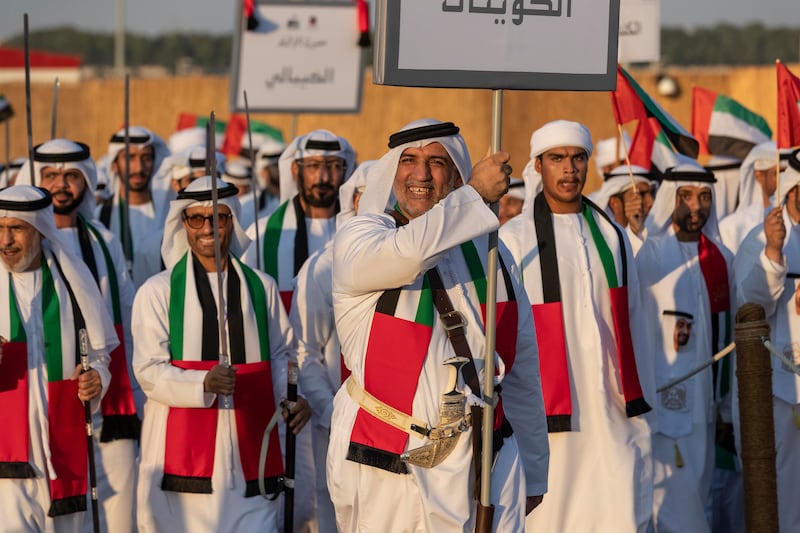 An Emirati on the parade ground smiles as he carries the name of his tribe.


