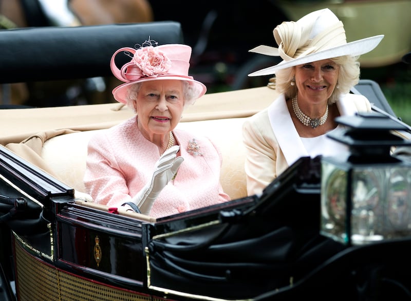 File photo: Britain's Queen Elizabeth II waves to the crowds with Camilla, Duchess of Cornwall  at right, as they arrive by carriage on the first day of the Royal Ascot horse race meeting in Ascot, England, Tuesday, June 18, 2013.   Queen Elizabeth II has offered her support to have the Duchess of Cornwall become Queen Camilla — using a special platinum jubilee message to make a significant decision in shaping the future of the monarchy. AP