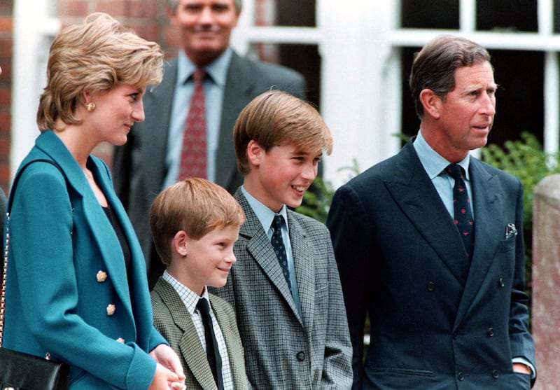 The Prince and Princess of Wales, and Prince Harry smile to photographers with Prince William on his first day of term at the Eton College on September 6, 1995