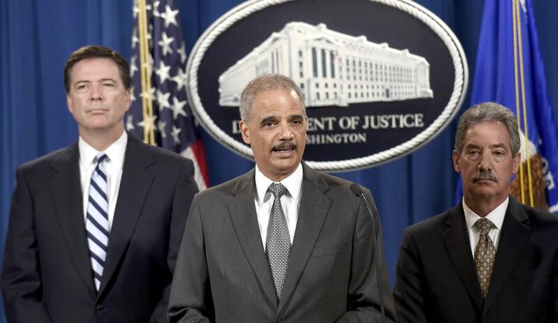 Attorney general Eric Holder, centre, FBI director James Comey, left, and deputy attorney general James Cole announces the deal between the US government and BNP Paribas. Susan Walsh / AP Photo