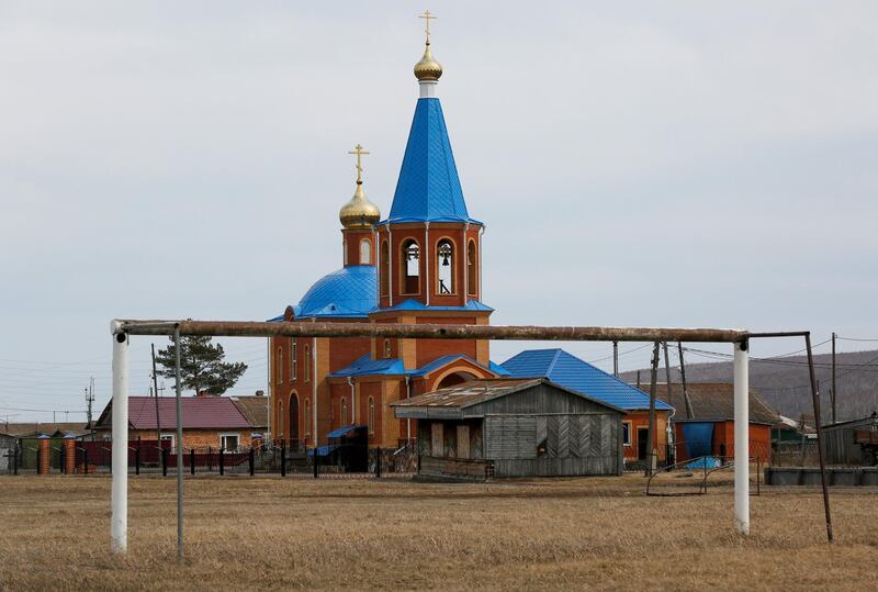 A goalpost stands in front of an Orthodox church in the Siberian village of Tyulkovo in Krasnoyarsk. Ilya Naymushin / Reuters