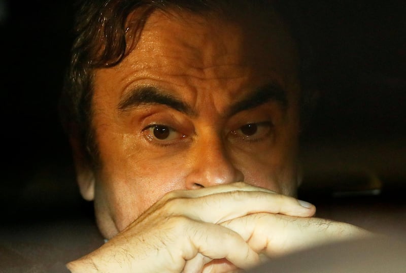 FILE PHOTO : Former Nissan Motor Chairman Carlos Ghosn sits inside a car as he leaves his lawyer's office after being released on bail from Tokyo Detention House, in Tokyo, Japan, March 6, 2019. REUTERS/Issei Kato/File Photo