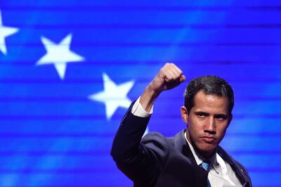 TOPSHOT - Venezuelan opposition leader and self declared acting president Juan Guaido gestures during meeting with workers and union leaders, in Caracas on February 14, 2019. Venezuela's military reinforced a blockade on Thursday morning at the border with Colombia where opposition leader Juan Guaido has vowed to bring in desperately-needed humanitarian aid despite President Nicolas Maduro's vow to keep it out. / AFP / Federico PARRA
