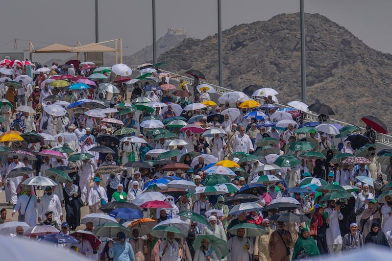 Muslim pilgrims use umbrellas to shelter from the sun as they arrive for the 'stoning of the devil', one of the final rites of Hajj, in Mina on Tuesday. AP Photo