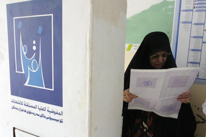 A woman reads her ballot paper before voting at a polling station in Basra during Iraq's parliamentary election. Reuters / Essam Al Sudani