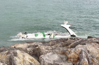 The vessel is partly submerged on the rocks near Mina Al Arab harbour. Courtesy: RAK Police