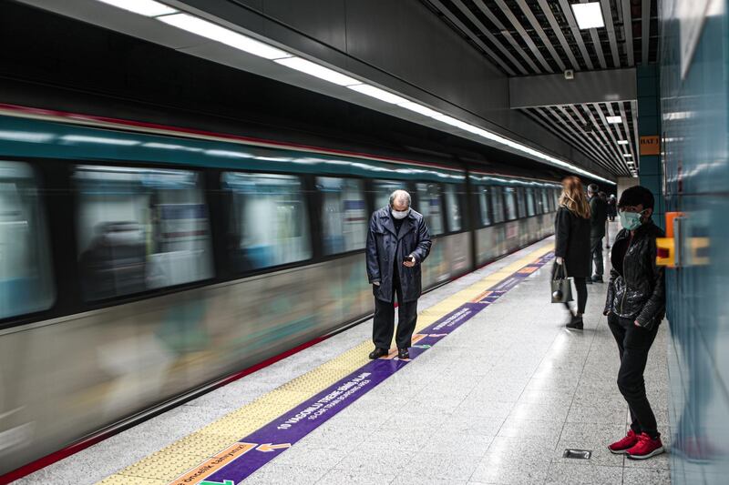 People wearing protective face masks wait at the Marmaray subway station in Istanbul, Turkey.  EPA