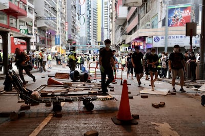 People move around the debris of roadblocks set by protesters during a protest against a planned national security law in the Wan Chai district in Hong Kong, China, on Sunday, May 24, 2020. Almost 200 politicians and legislators from 23 countries issued a joint statement criticizing China’s plans to impose a sweeping national security law in Hong Kong, and warned that it could spark more protests in the city, Radio and Television Hong Kong reported. Photographer: May James/Bloomberg