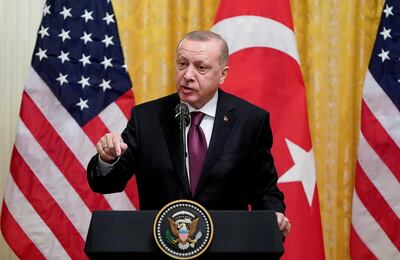 FILE PHOTO: Turkish President Tayyip Erdogan answers questions during a joint news conference with U.S. President Donald Trump at the White House in Washington, U.S., November 13, 2019. REUTERS/Joshua Roberts/File Photo