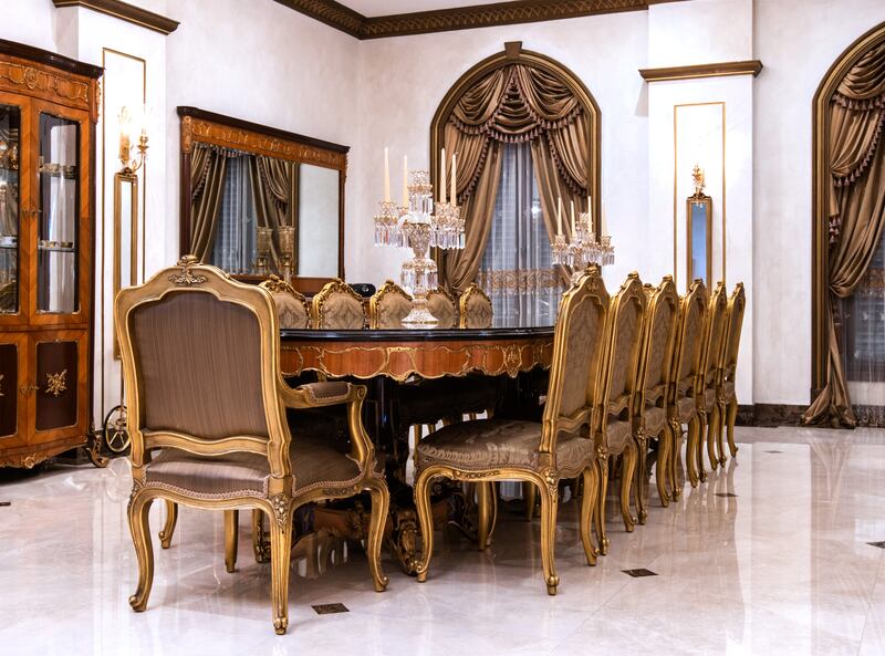 The hand-carved dining table is infused with copper.