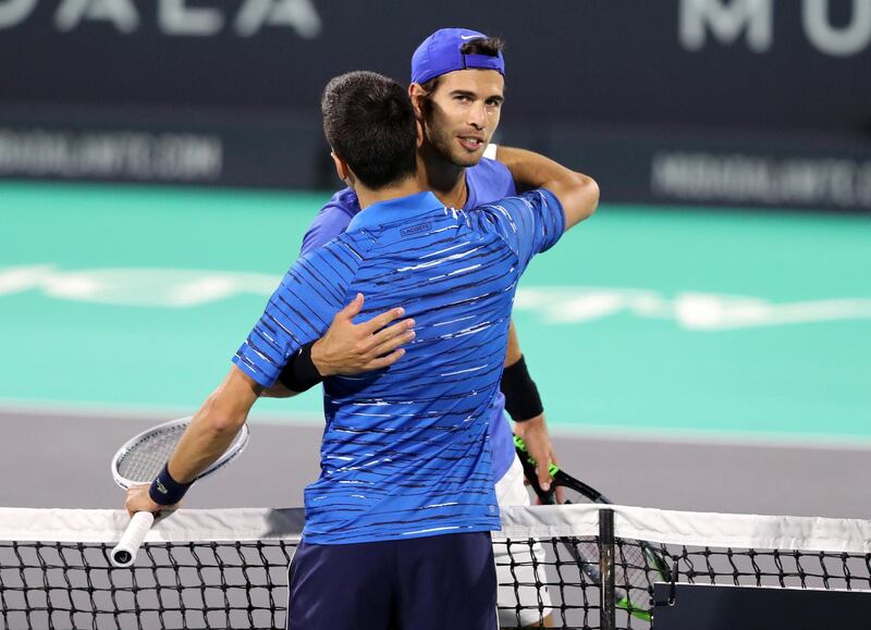 Abu Dhabi, United Arab Emirates - Reporter: Jon Turner: Novak Djokovic celebrates by giving his opponent Karen Khachanov a hug after winning the third place play-off between Novak Djokovic v Karen Khachanov at the Mubadala World Tennis Championship. Saturday, December 21st, 2019. Zayed Sports City, Abu Dhabi. Chris Whiteoak / The National