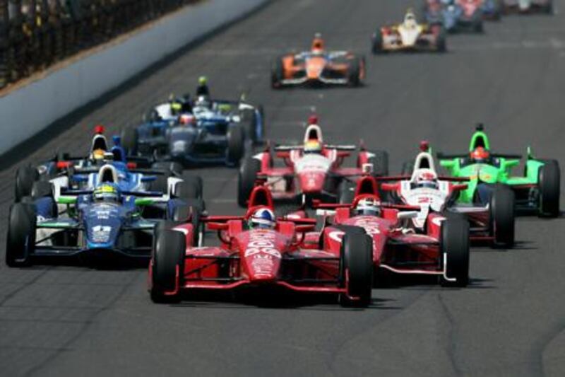 INDIANAPOLIS, IN - MAY 27: Dario Franchitti of Scotland, driver of the #50 Target Chip Ganassi Racing Honda, leads a pack of cars including Tony Kannan, driver of the #11 GEICO-Mouser Electronics KVRT Chevrolet and Scott Dixon of New Zealand, driver of the #9 Target Chip Ganassi Racing Honda during the IZOD IndyCar Series 96th running of the Indianpolis 500 mile race at the Indianapolis Motor Speedway on May 27, 2012 in Indianapolis, Indiana.   Nick Laham/Getty Images/AFP== FOR NEWSPAPERS, INTERNET, TELCOS & TELEVISION USE ONLY ==

