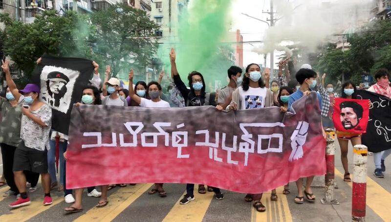 People carry banners as they protest in Yangon, Myanmar, in this still image from video obtained from social media dated June 14, 2021. The banner (front C) reads: "revolt of general strikes". NEWS AMBASSADOR via REUTERS   ATTENTION EDITORS - THIS IMAGE HAS BEEN SUPPLIED BY A THIRD PARTY. MANDATORY CREDIT. NO RESALES. NO ARCHIVES. MYANMAR OUT. NO COMMERCIAL OR EDITORIAL SALES IN MYANMAR