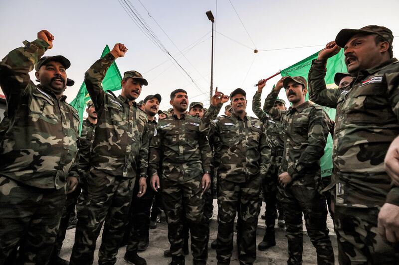 Members of Iraq's Popular Mobilisation Forces paramilitaries chant slogans ahead of the funeral of members of the group killed in a US strike in Baghdad in January. AFP