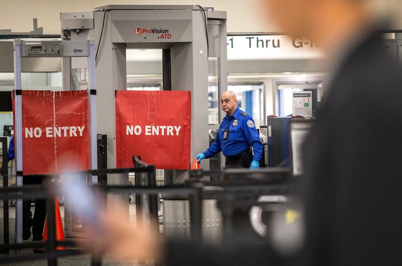 epa07278516 A TSA officer closes the entrance of the Miami International Airport's Terminal G, during the ongoing the government shutdown, in Miami, Florida, USA, 12 January 2019. The current partial shutdown of the US federal government has become the longest in US history, on 12 January, surpassing the previous 21-day shutdown of 1995-1996. Over 800,000 federal employees are impacted by the shutdown, with around 400,000 furloughed and being paid later and the rest deemed 'essential', who must work without pay, though retroactive pay is expected, with 11 January marking the first missed paycheck.  EPA/CRISTOBAL HERRERA