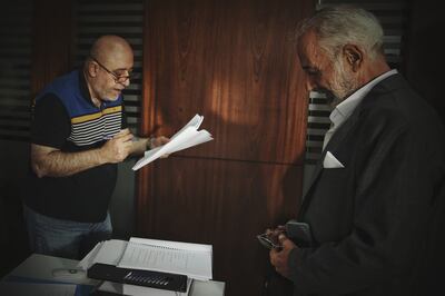 Syrian director Ahmed Ibrahim Ahmed, left, and prominent Syrian actor Ayman Zeidan reading over lines during the shooting of a new family comedy movie. Sarab Production via Reuters