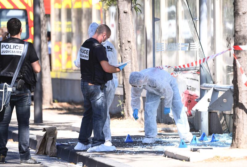 French criminal police join forensic police as they search the site following a car crash on August 21, 2017, in the southern Mediterranean city of Marseille.  
At least one person has died in Marseille after a car crashed into people waiting at two different bus stops in the southern French port city, police sources told AFP, adding that the suspected driver had been arrested afterwards. The police sources, who asked not to be identified, did not say whether the incident was being treated as a terror attack or an accident.  / AFP PHOTO / boris HORVAT