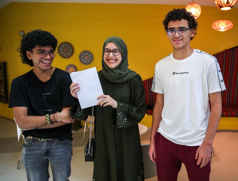 (L-R) Chris Rebello, Deema Alqemzi and Haroun Ouali of Repton School in Abu Dhabi congratulate each other after they receive their A-level grades. Victor Besa / The National