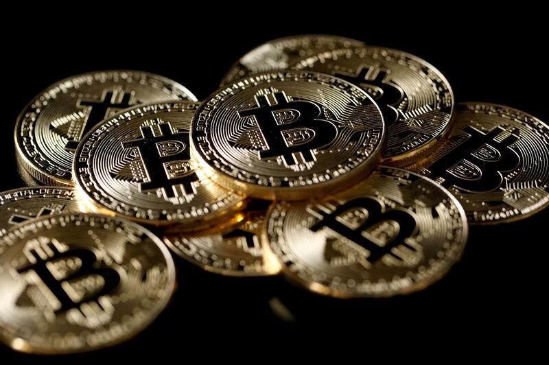 FILE PHOTO: FILE PHOTO: A collection of Bitcoin (virtual currency) tokens are displayed in this picture illustration taken December 8, 2017. REUTERS/Benoit Tessier/File Photo