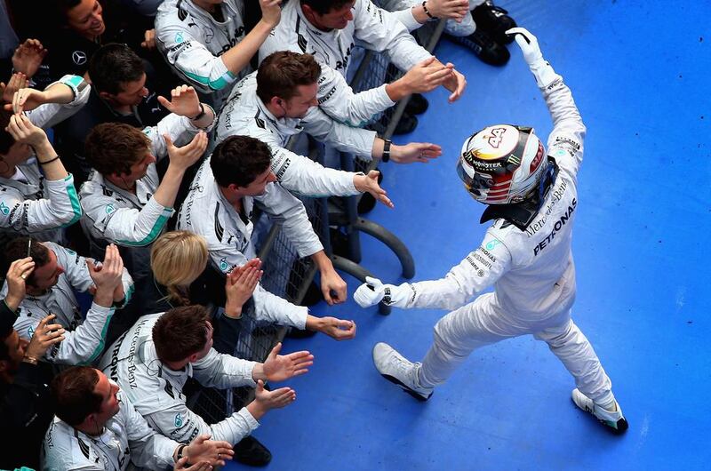 Lewis Hamilton of Mercedes-GP celebrates his victory with his team following the Chinese Grand Prix at the Shanghai International Circuit on Sunday. Clive Mason / Getty Images / April 20, 2014