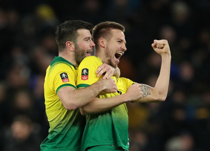 Norwich City's Marco Stiepermann and Grant Hanley celebrate winning the penalty shootout. Reuters