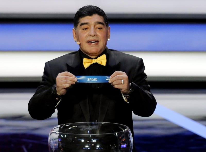 epa06362052 Draw assistant, former Argentine international Diego Maradona shows the ticket of Spain during the Final Draw of the FIFA World Cup 2018 at the State Kremlin Palace in Moscow, Russia, 01 December 2017. The FIFA World Cup 2018 will take place from 14 June until 15 July 2018 in Russia.  EPA/YURI KOCHETKOV