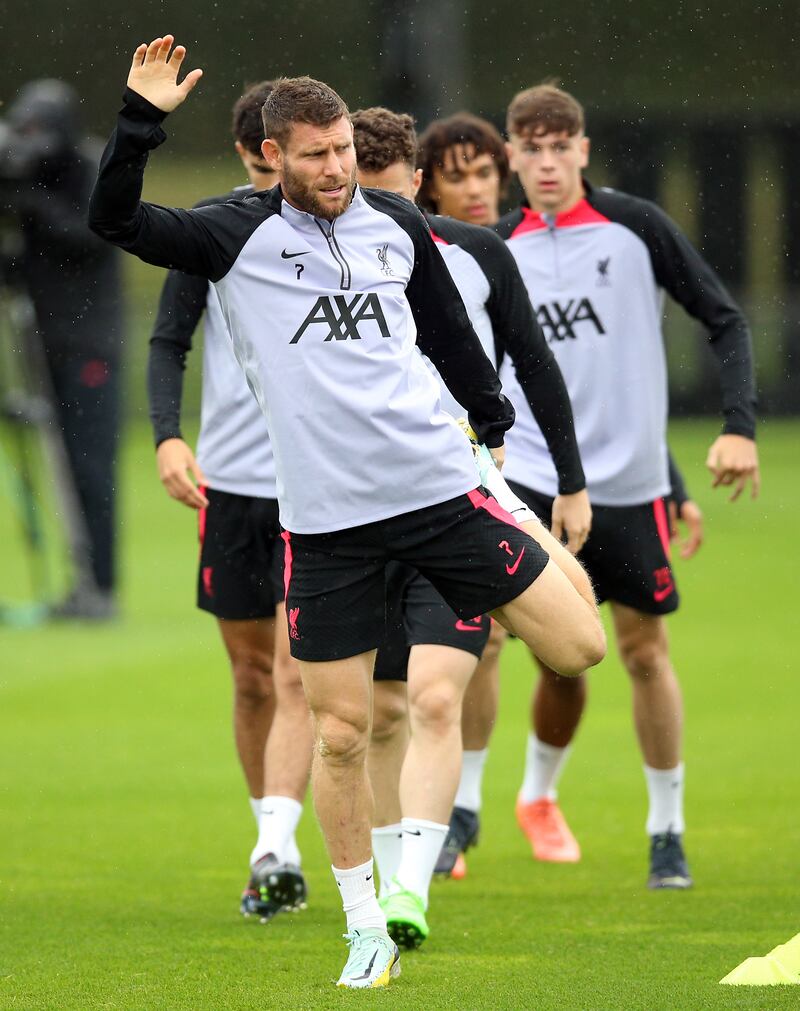 Liverpool's James Milner stretches at training. PA