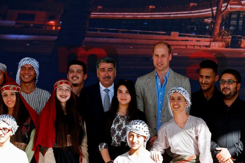 Britain's Prince William poses for a group picture with the mayor of Ramallah Musa Hadid and Palestinian children during a reception at the municipality in the West Bank city. Abbas Momani / AFP