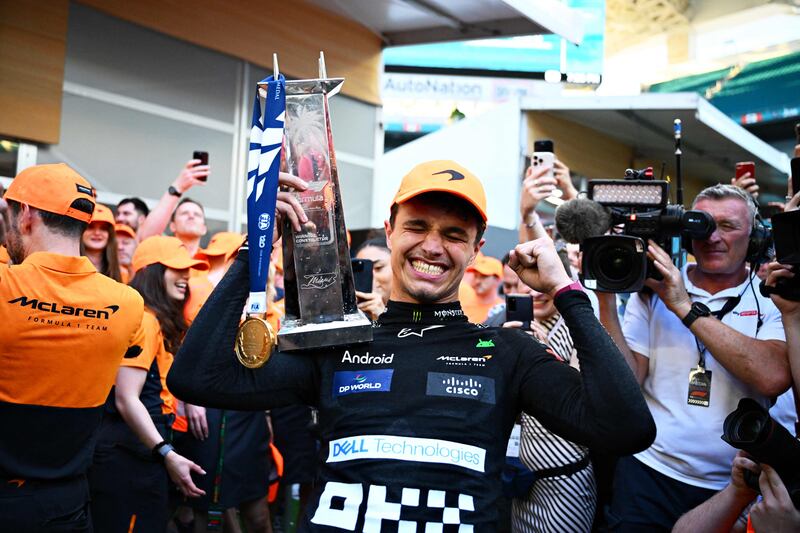 McLaren driver Lando Norris celebrates with the Miami Grand Prix trophy after winning the race at Miami International Autodrome on May 5, 2024 in Miami, Florida. Getty Images