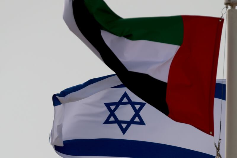 Flags of the UAE and Israel fly upon the arrival of Israeli and US delegates at Abu Dhabi International Airport, earlier this year. New cases of the coronavirus have fallen in Israel and the UAE in recent weeks.  Reuters