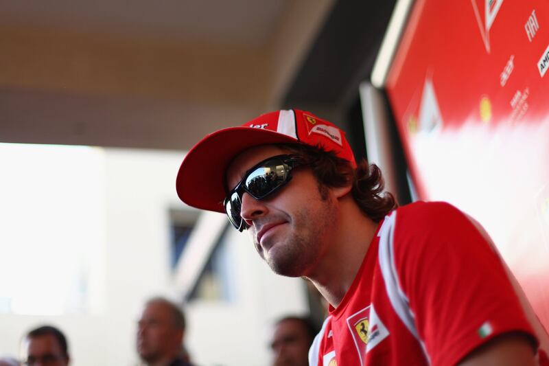 ABU DHABI, UNITED ARAB EMIRATES - NOVEMBER 10:  Fernando Alonso of Spain and Ferrari is interviewed by the media during previews to the Abu Dhabi Formula One Grand Prix at the Yas Marina Circuit on November 10, 2011 in Abu Dhabi, United Arab Emirates.  (Photo by Clive Mason/Getty Images) *** Local Caption ***  132047275.jpg