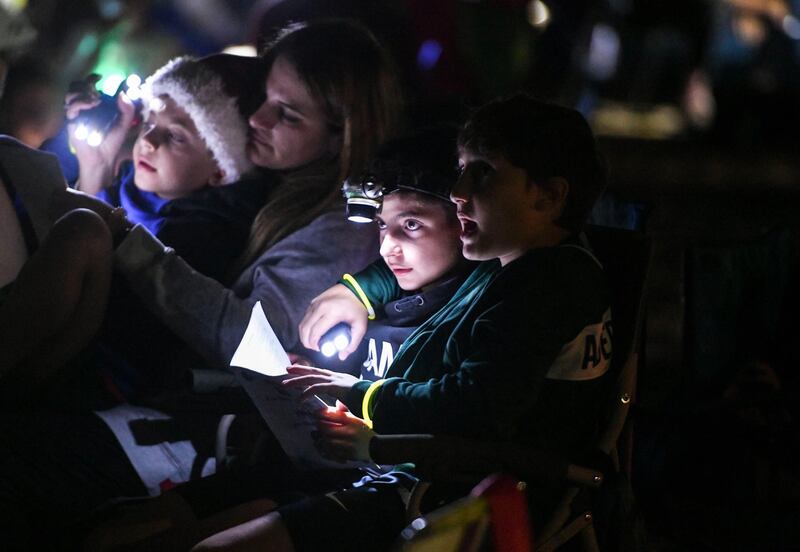 Abu Dhabi, United Arab Emirates - Young children participate in singing Christmas carols by candlelight in the desert. Khushnum Bhandari for The National