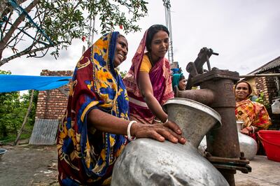 A water supply facility brings smiles to women in Bangladesh. Courtesy of Local Environment Development and Agricultural Research Society